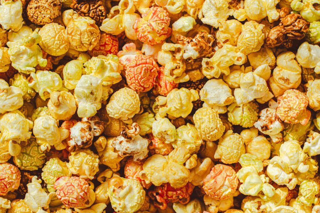 A vibrant array of multicolored popcorn kernels, showcasing texture and flavor diversity.
